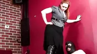 Tattooed dominatrix on heels torturing cock